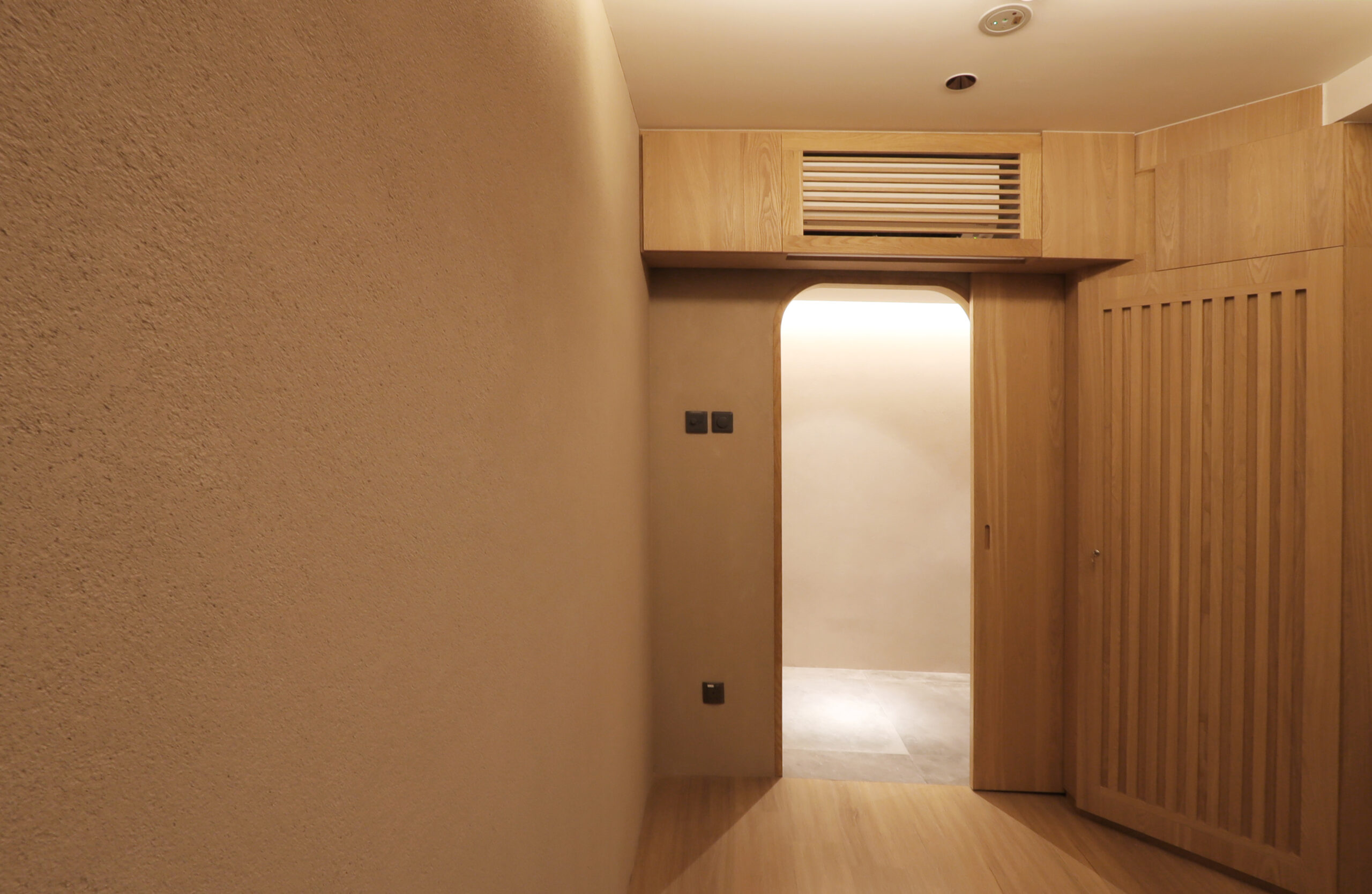 Clay lime plaster feature wall in a treatment room, natural matte finish